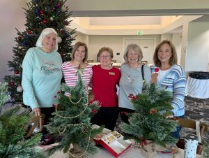 Decorating small Christmas trees for local hospice patients.