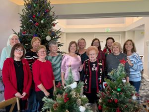 Decorating small Christmas trees for local hospice patients.