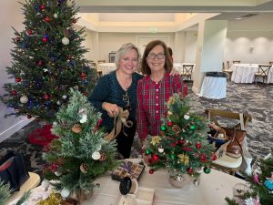 Decorating small Christmas trees for local hospice patients.