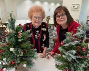 Decorating small Christmas trees for local hospice patients.